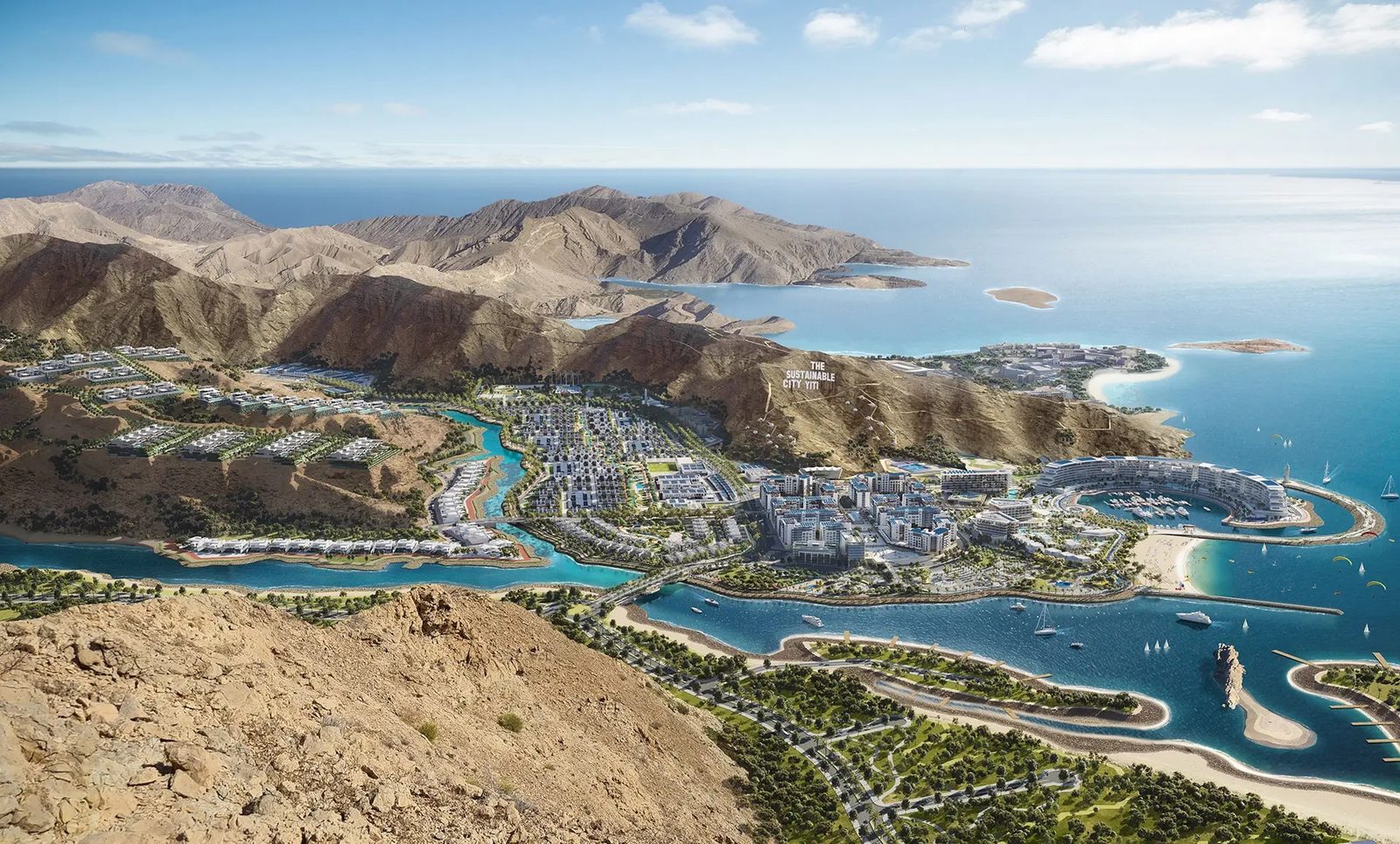 Wide aerial view of the city between the mountains and the sea